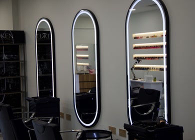 Modern styling chairs and mirrors at Cynthilante Beauty Salon, Dubai, Dubai, AE, showcasing a sleek ambiance.