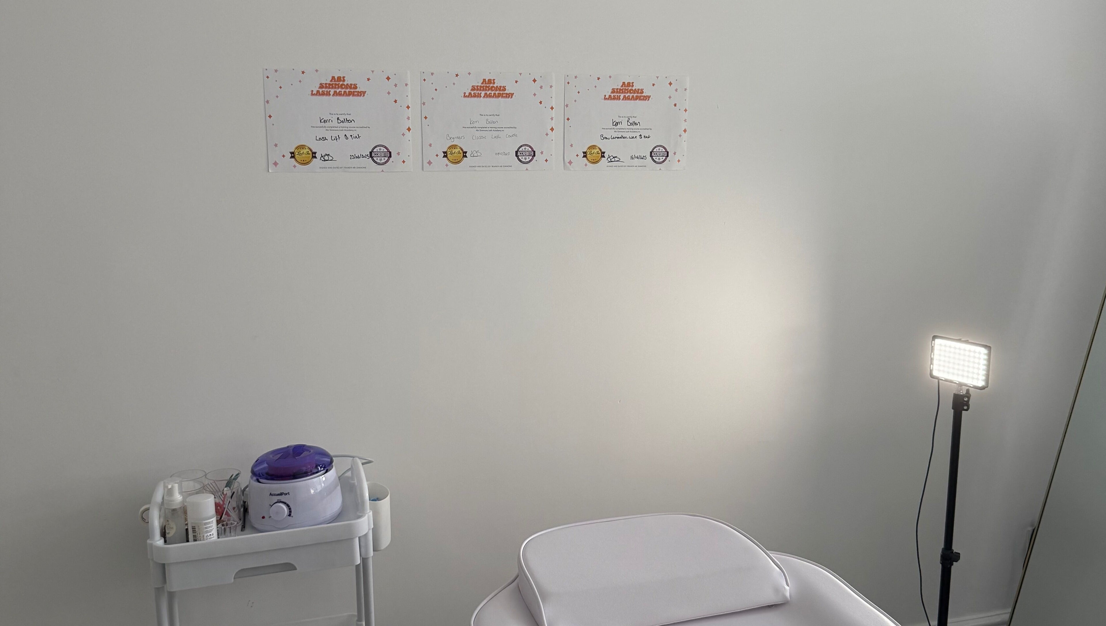 Calm treatment room at Shoreline Lash Lounge, Bournemouth, England, GB; certificates of excellence displayed.