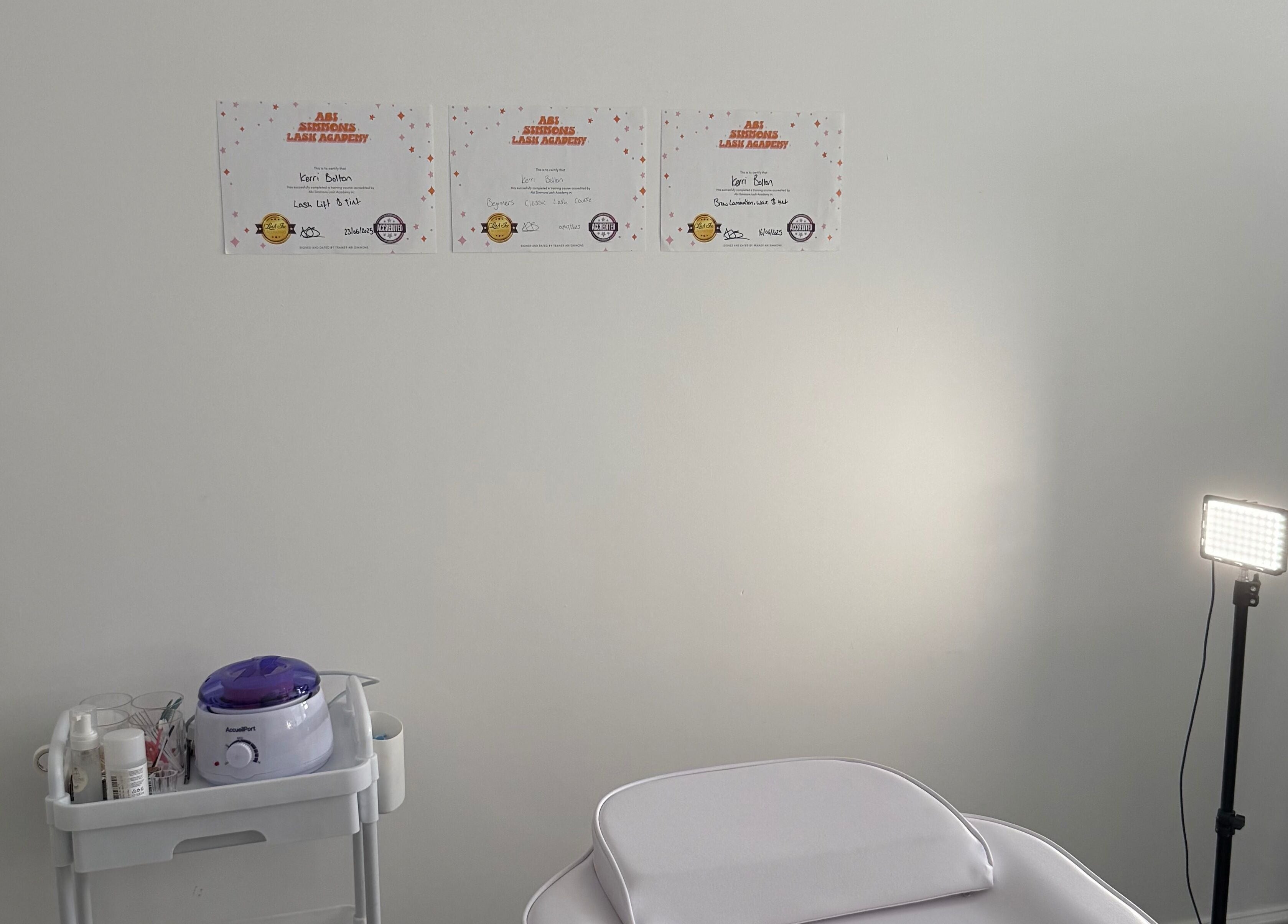 Calm treatment room at Shoreline Lash Lounge, Bournemouth, England, GB; certificates of excellence displayed.