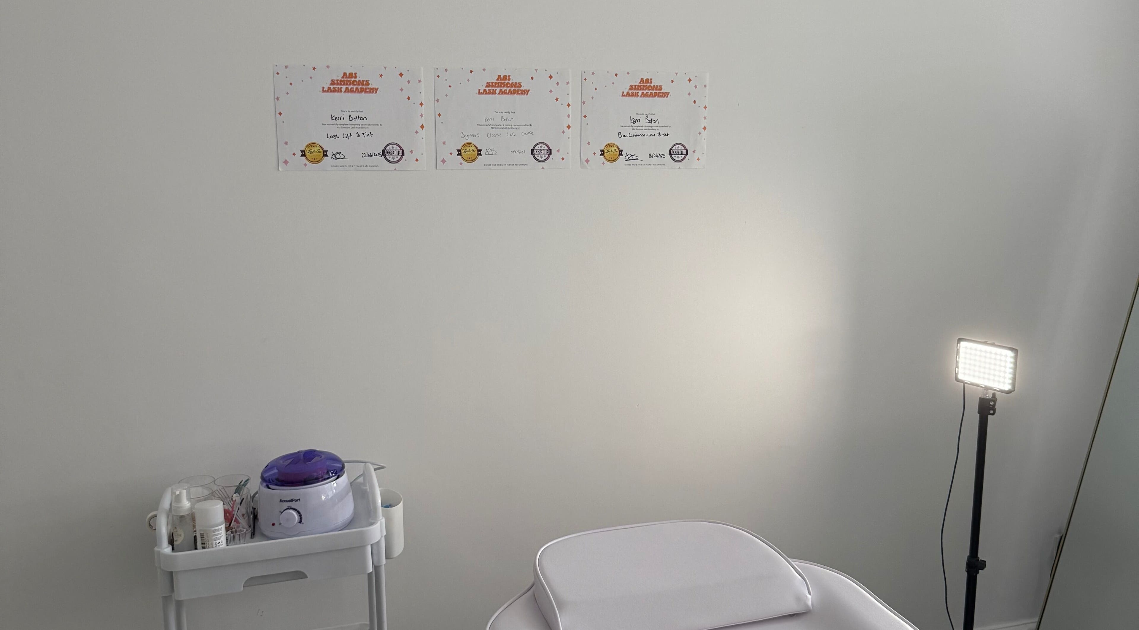 Calm treatment room at Shoreline Lash Lounge, Bournemouth, England, GB; certificates of excellence displayed.