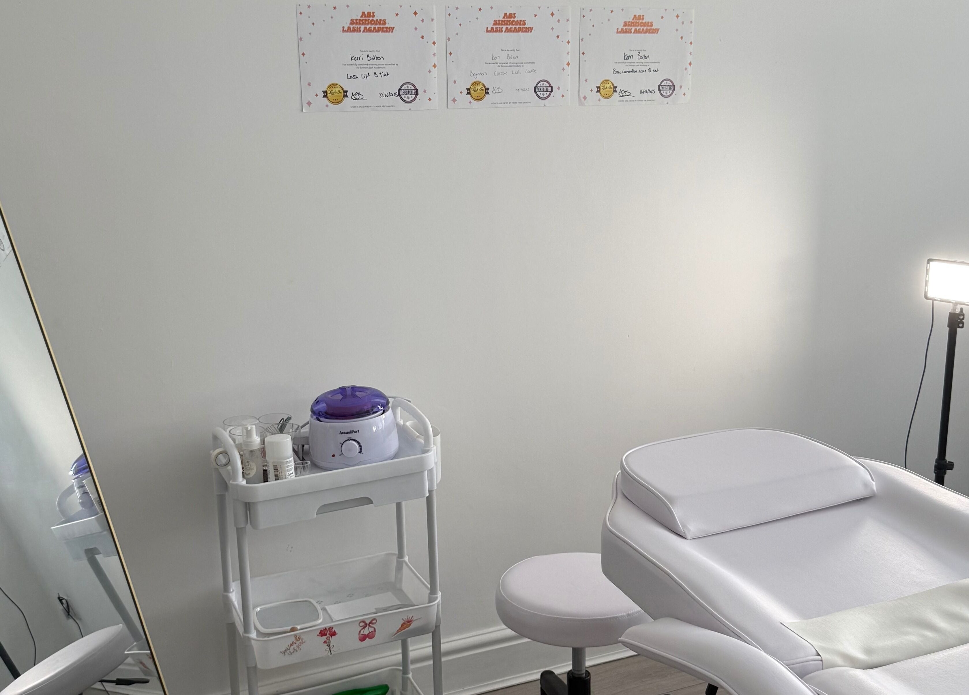 Treatment room with spa bed and mirror at Shoreline Lash Lounge, Bournemouth, England, GB.