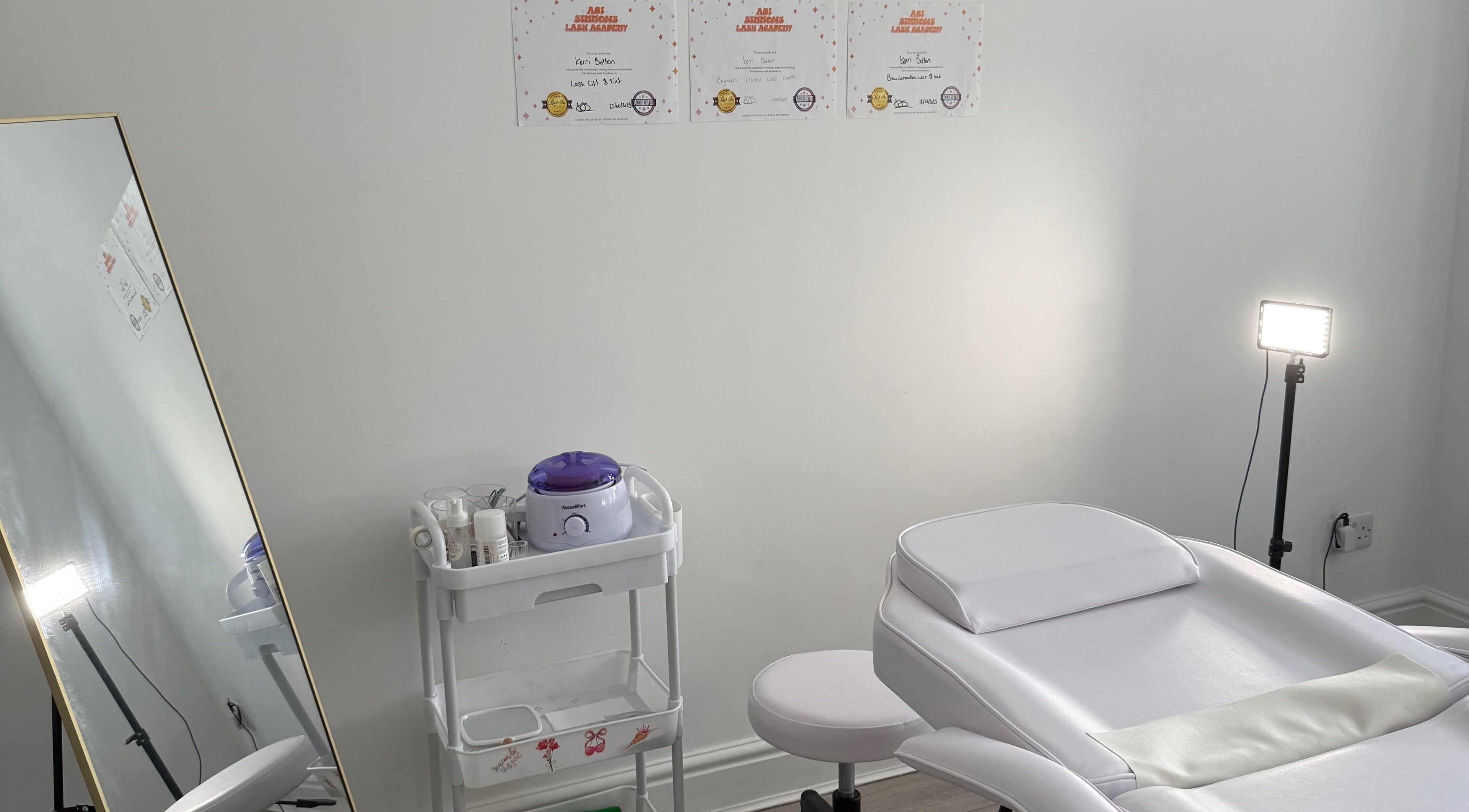 Treatment room with spa bed and mirror at Shoreline Lash Lounge, Bournemouth, England, GB.