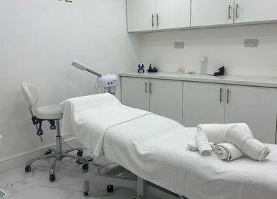 Serene treatment room at JA Sports Injuries in Oldbury, England, GB, featuring a white massage bed and clean decor.