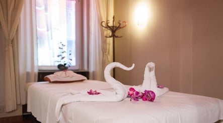 Tranquil massage room at Thai Massage Narodni in Hlavní Město Praha, CZ, featuring elegant towel swans.