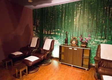Relaxing massage chairs at Thai Massage Narodni, Hlavní Město Praha, Hlavní Město Praha, CZ with forest decor.