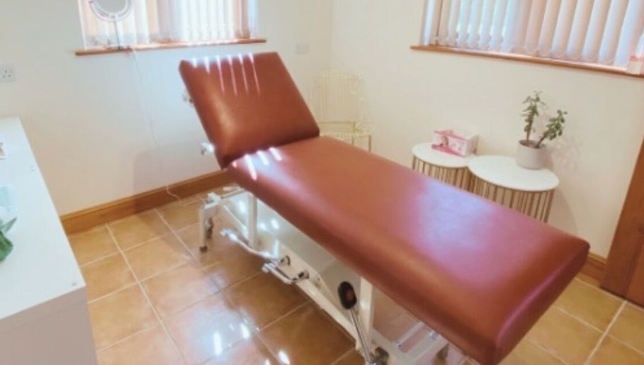 Relaxing treatment room at Wymondham Aesthetics in Wicklewood, England, GB featuring a comfortable brown recliner.