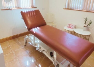 Relaxing treatment room at Wymondham Aesthetics in Wicklewood, England, GB featuring a comfortable brown recliner.