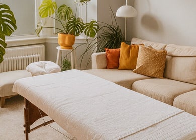 Relaxing massage room at Natural Body Massage, Glasgow, Scotland, GB with plants and cozy seating.