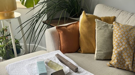 Relaxing sofa with plush pillows and spa products at Natural Body Massage, Glasgow, Scotland, GB.