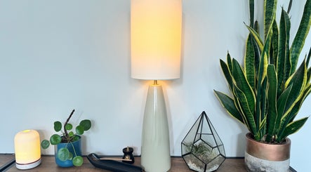 Elegant lamp and greenery decor at Natural Body Massage, Glasgow, Scotland, GB, enhancing a calming ambiance.