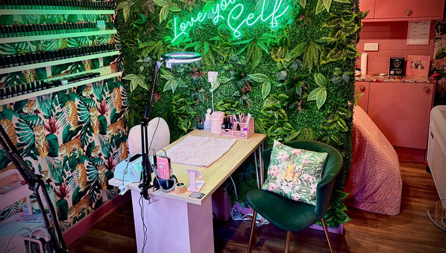 Tropical-themed nail station at The Little Beauty Cabin, Hadston, England, GB, with lush greenery and vibrant decor.