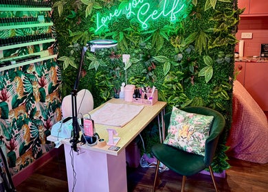 Tropical-themed nail station at The Little Beauty Cabin, Hadston, England, GB, with lush greenery and vibrant decor.
