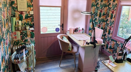 Nail station in The Little Beauty Cabin, Hadston, England, GB with tropical decor and pink accents.