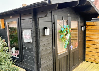 Cozy exterior of The Little Beauty Cabin in Hadston, England, showcasing a welcoming entrance.