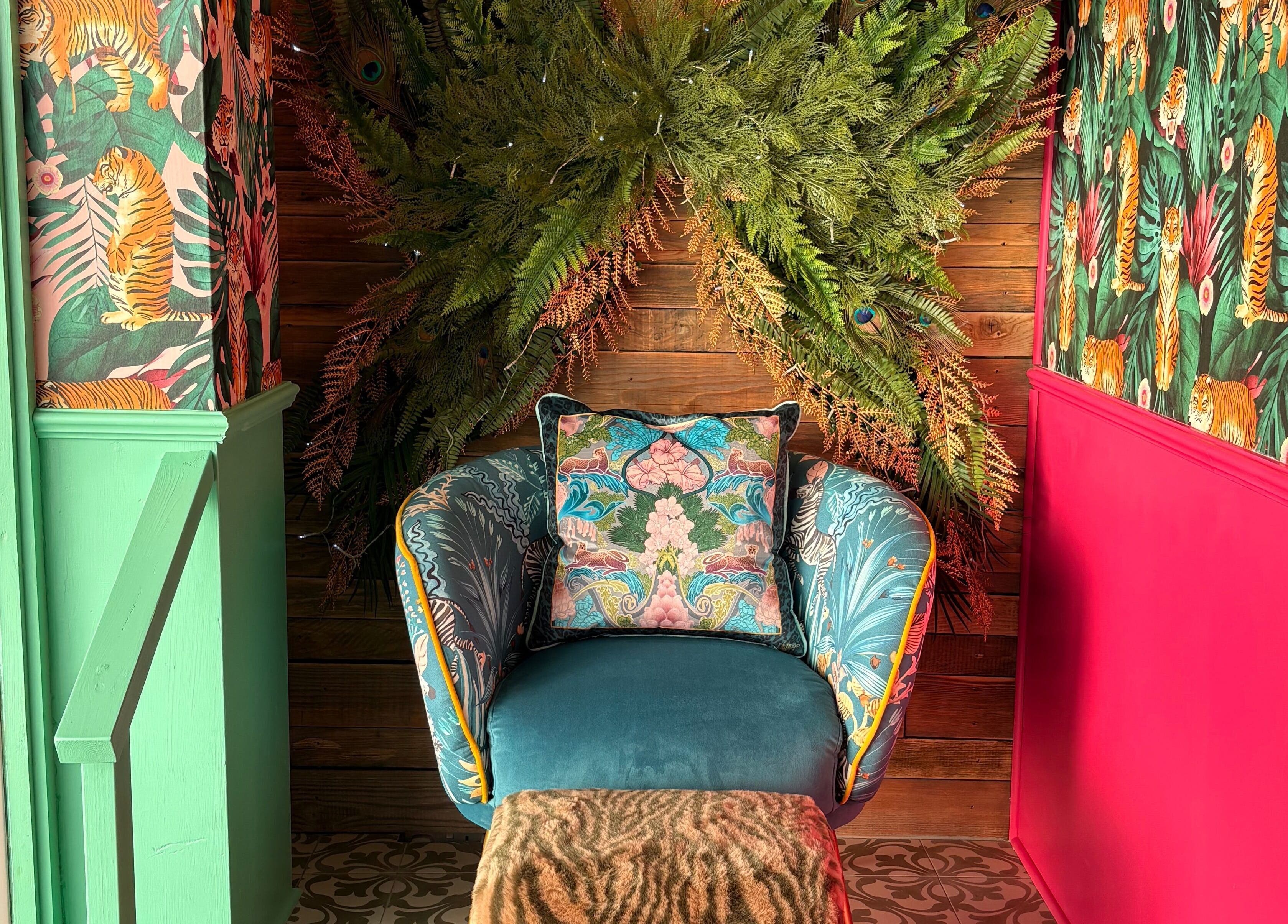 Vibrant chair with tropical décor at The Little Beauty Cabin, Hadston, England, GB.