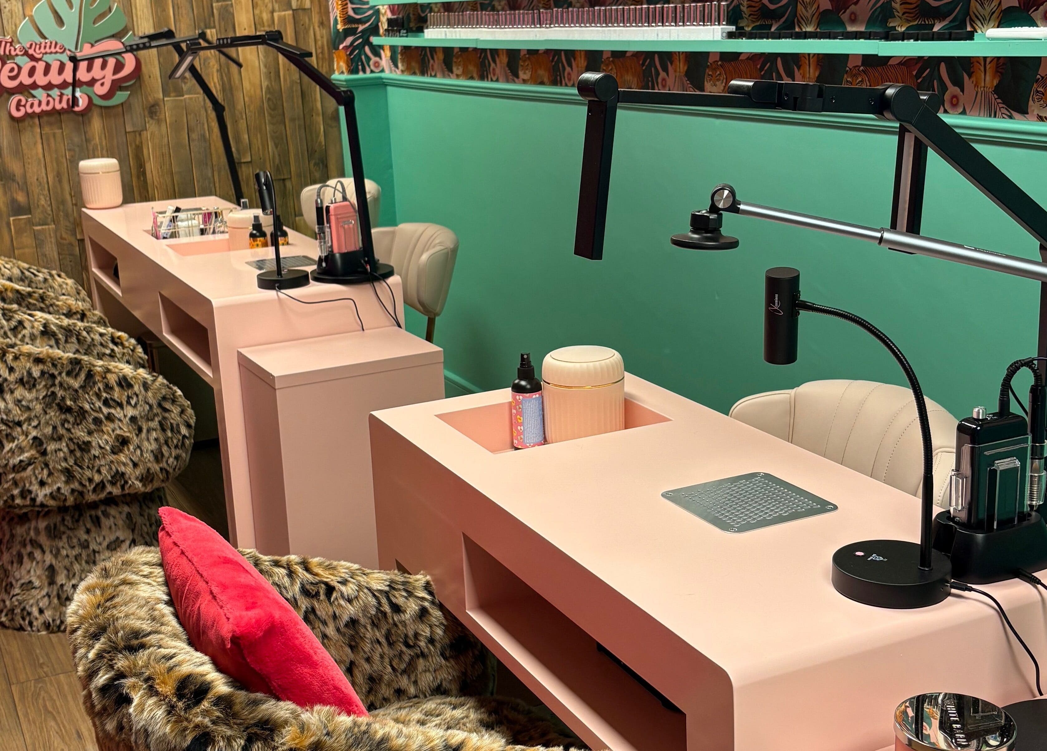 Stylish nail stations at The Little Beauty Cabin, Hadston, England, GB with vibrant decor and plush seating.