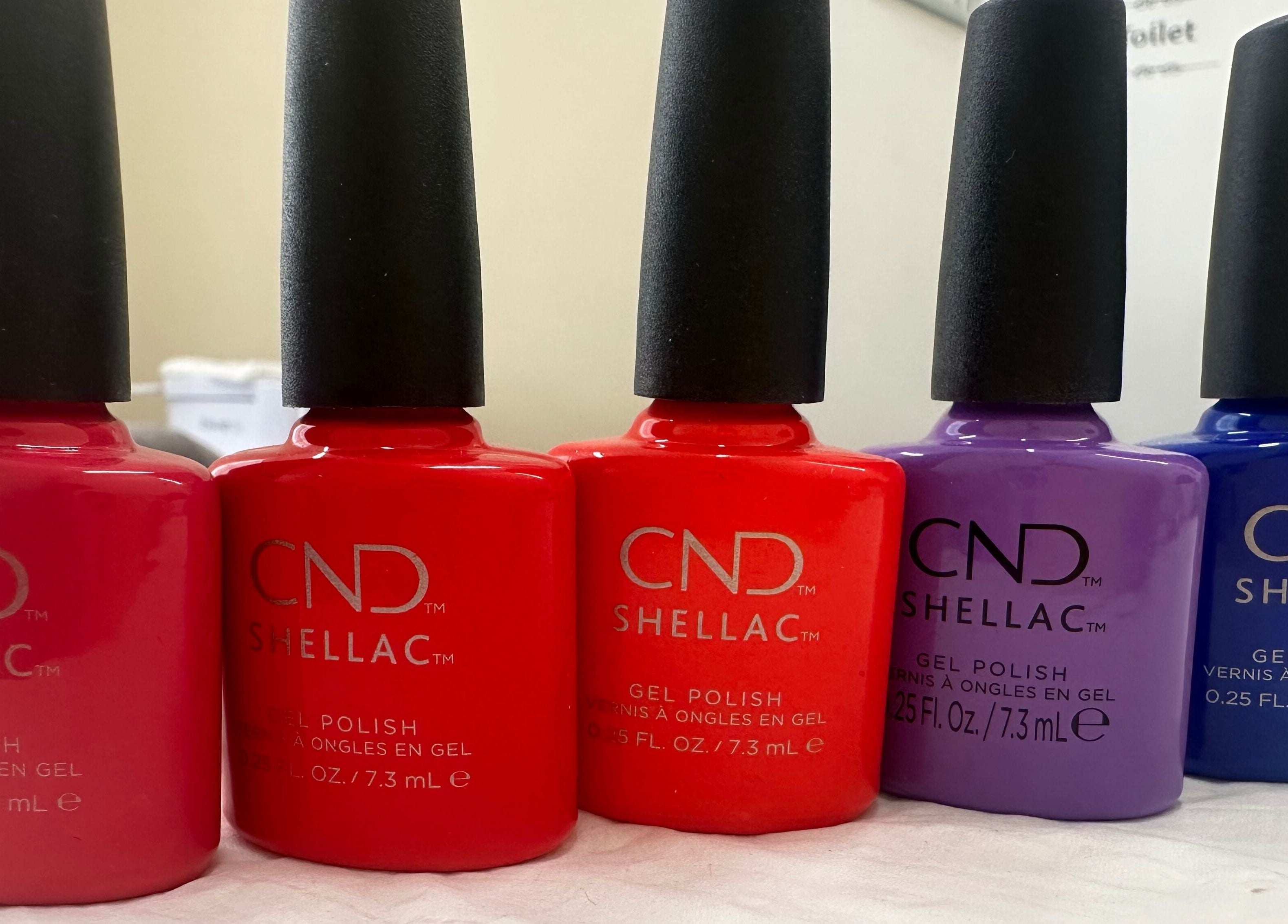 Vibrant nail polish bottles at The Bare Beauty - Waxing Studio, London, England, GB enhancing nail care experience.