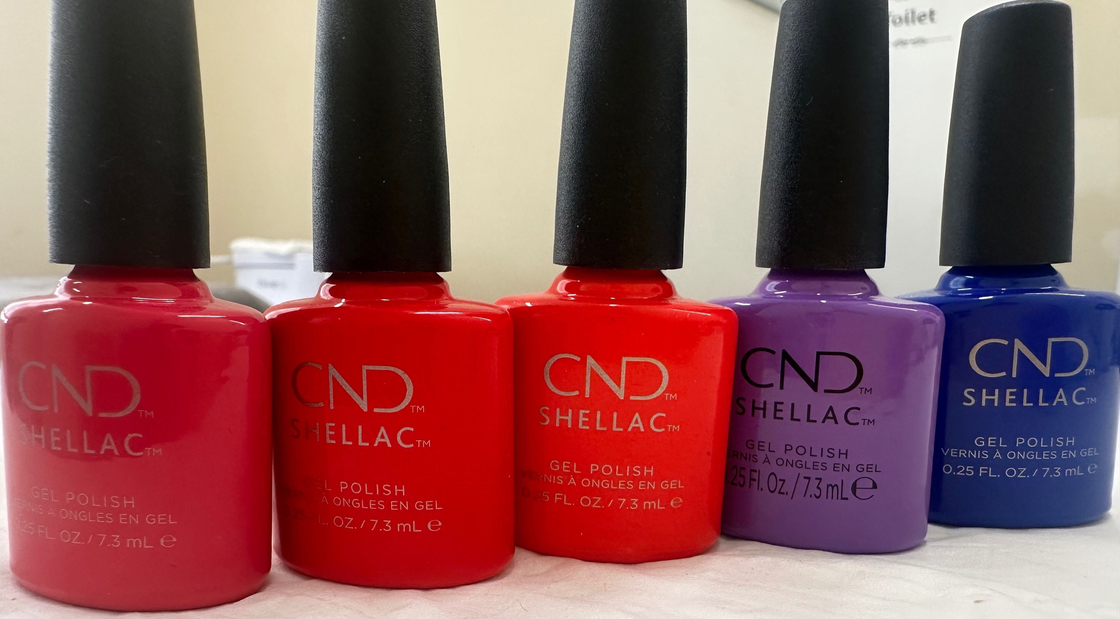 Vibrant nail polish bottles at The Bare Beauty - Waxing Studio, London, England, GB enhancing nail care experience.