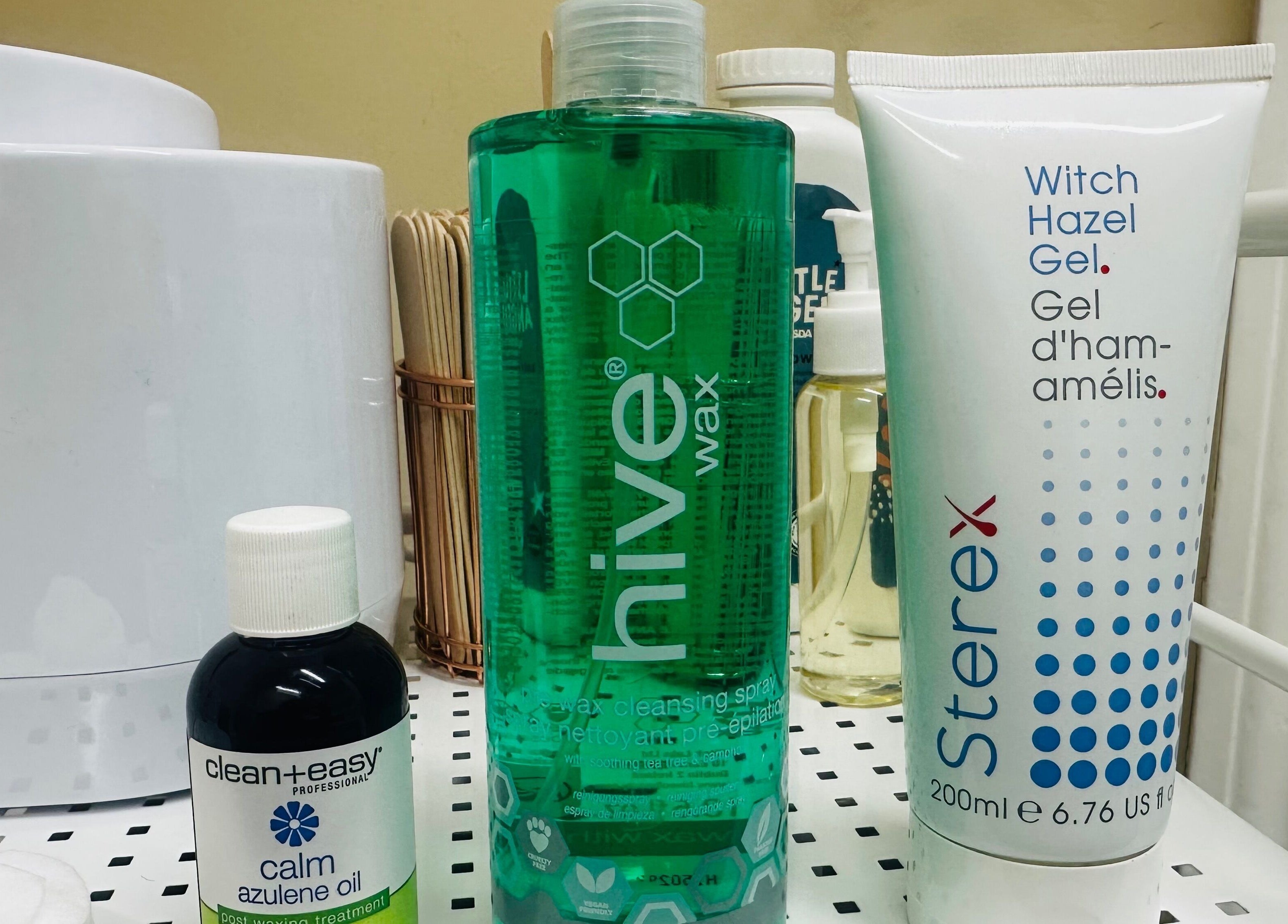 Waxing products at The Bare Beauty - Waxing Studio, London, England, GB, including Hive wax and azulene oil.
