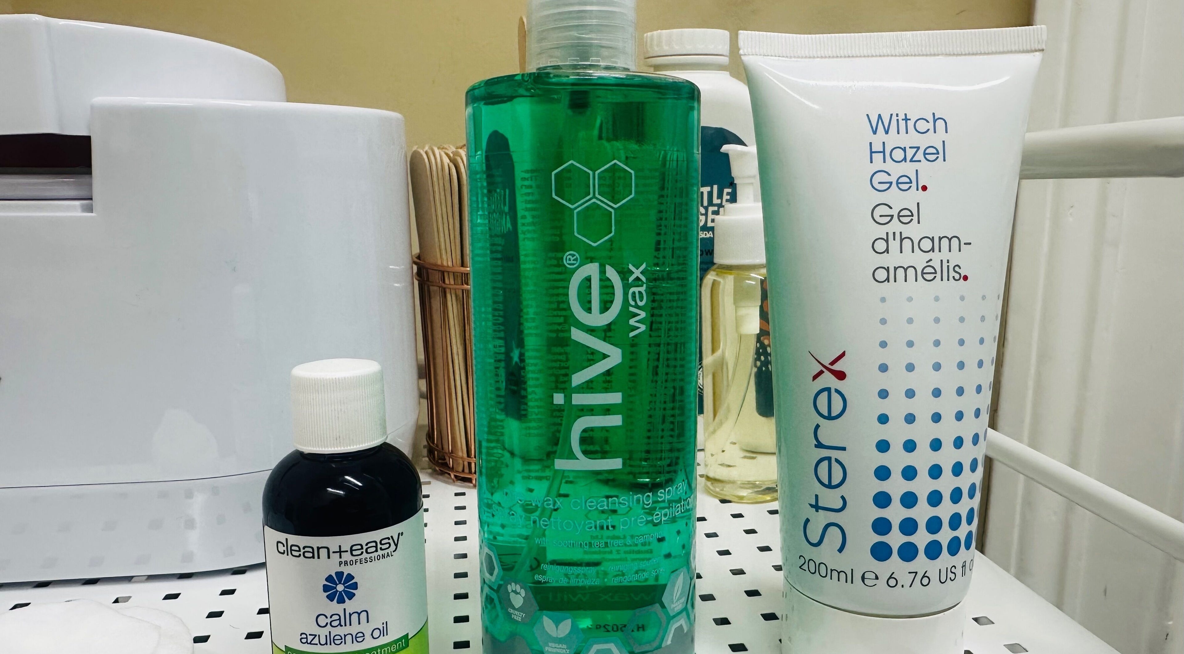 Waxing products at The Bare Beauty - Waxing Studio, London, England, GB, including Hive wax and azulene oil.