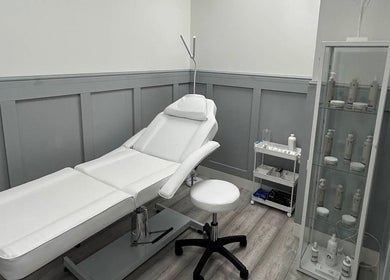 Elegant treatment room at Aceso Aesthetics, Northwich, England, GB featuring a modern therapy bed.