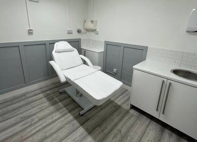 Calm treatment room at Aceso Aesthetics in Northwich, England, GB, featuring a comfortable white chair and modern decor.