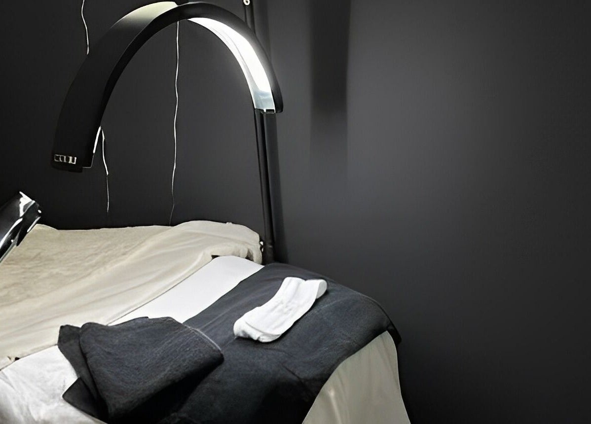 Spa bed setup at Bare Face Esthetics, Cheshire, Connecticut, US with soft towels and modern lighting.