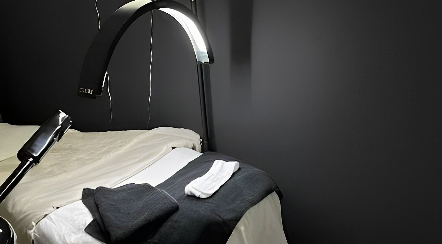 Spa bed setup at Bare Face Esthetics, Cheshire, Connecticut, US with soft towels and modern lighting.