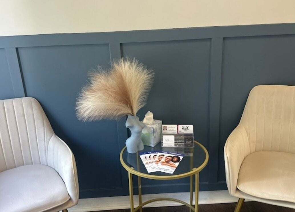 Elegant sitting area at Bare Face Esthetics, Cheshire, Connecticut, US, featuring stylish chairs and decor.
