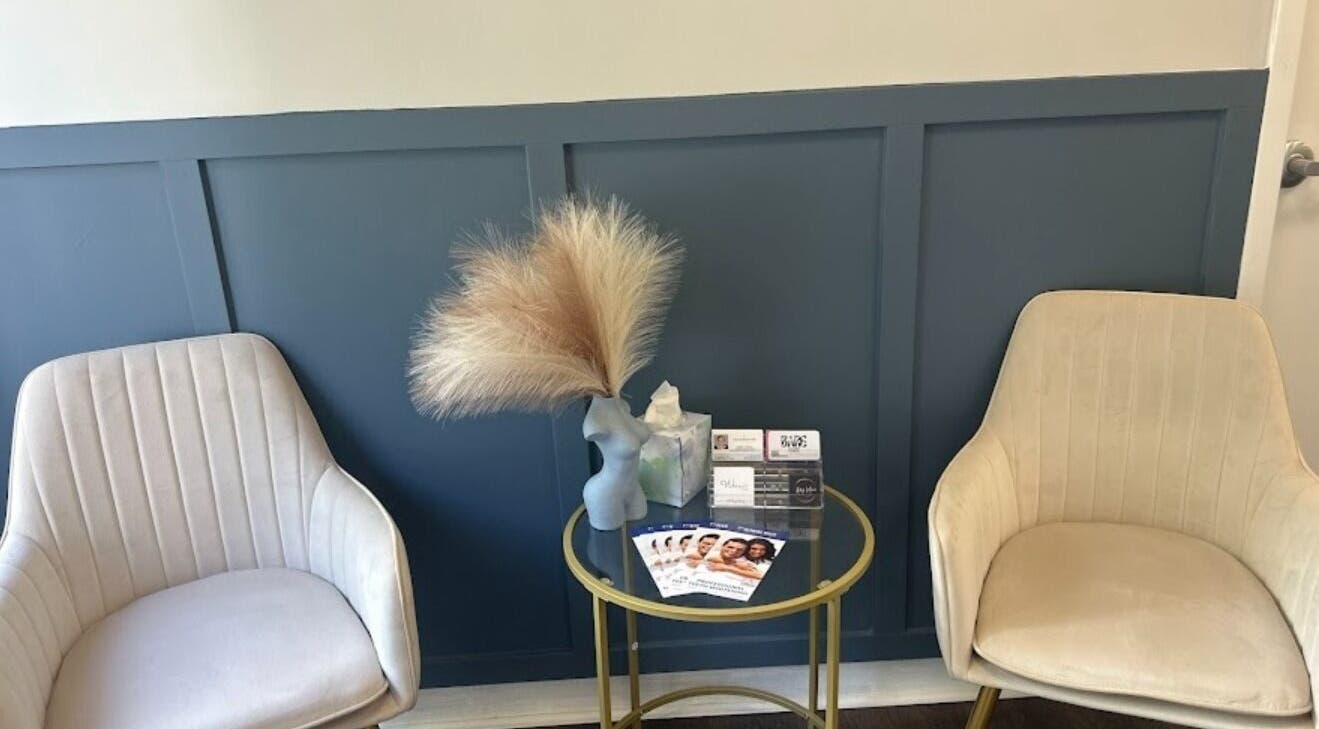 Elegant sitting area at Bare Face Esthetics, Cheshire, Connecticut, US, featuring stylish chairs and decor.
