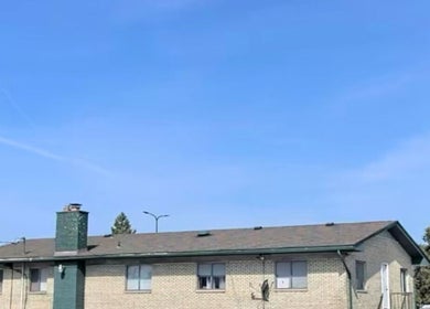 Front view of Naturally Auinye in Eastpointe, Michigan, US with a clear blue sky backdrop.
