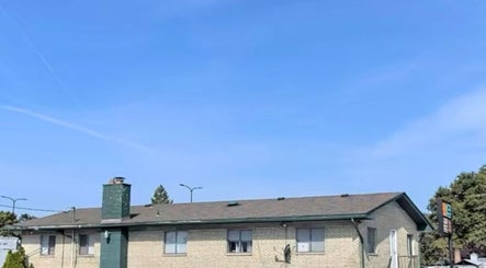 Front view of Naturally Auinye in Eastpointe, Michigan, US with a clear blue sky backdrop.