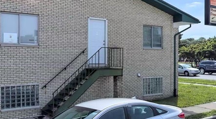 The exterior view of Naturally Auinye located in Eastpointe, Michigan, US, showcasing its distinctive brick facade.