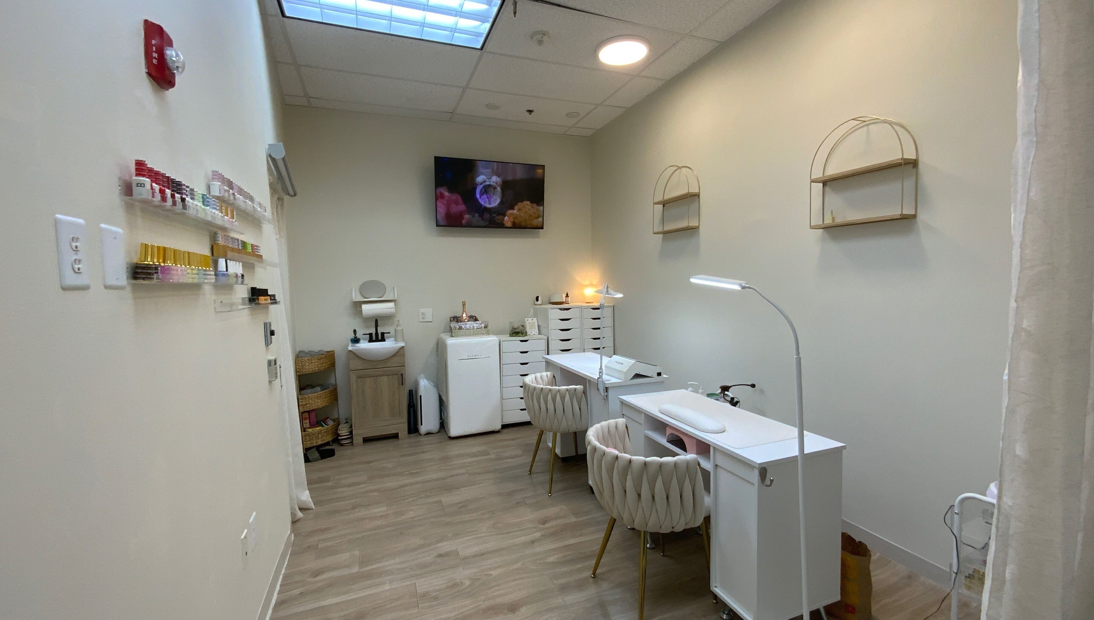 Cozy interior of Ruby's Nailz and Lashes in Boca Raton, Florida, US featuring nail stations and polish display.
