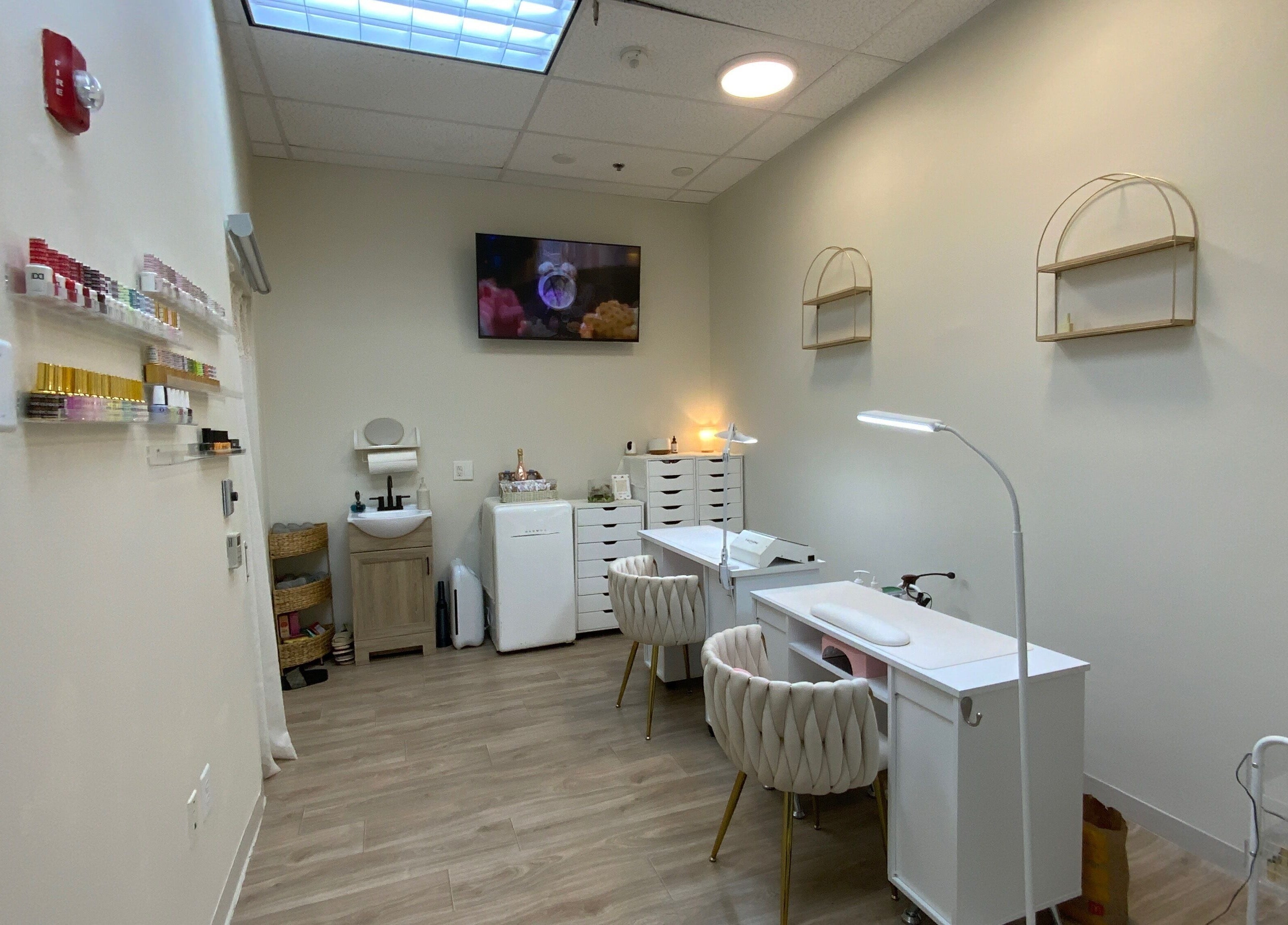 Cozy interior of Ruby's Nailz and Lashes in Boca Raton, Florida, US featuring nail stations and polish display.
