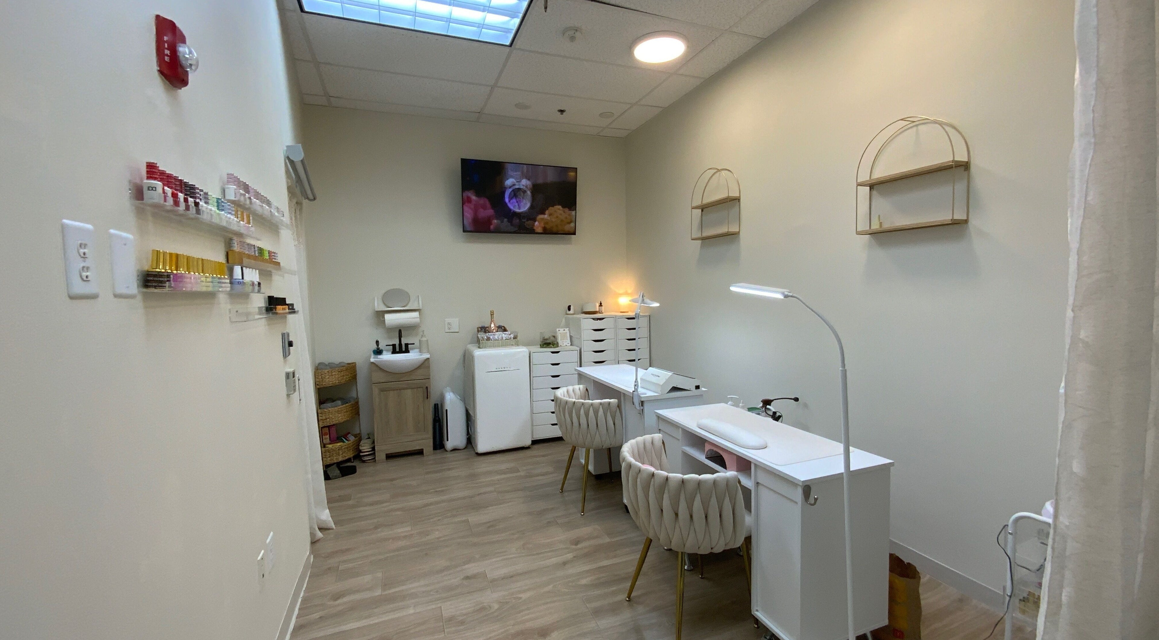 Cozy interior of Ruby's Nailz and Lashes in Boca Raton, Florida, US featuring nail stations and polish display.