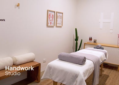 Relaxing massage room at Handwork Studio, Windsor, Victoria, AU with towels on a treatment bed.