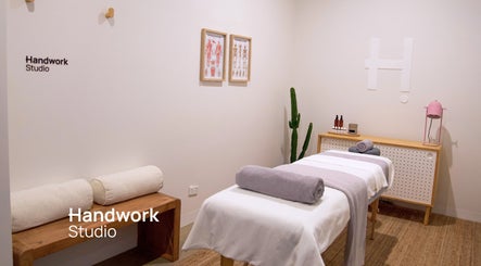 Relaxing massage room at Handwork Studio, Windsor, Victoria, AU with towels on a treatment bed.