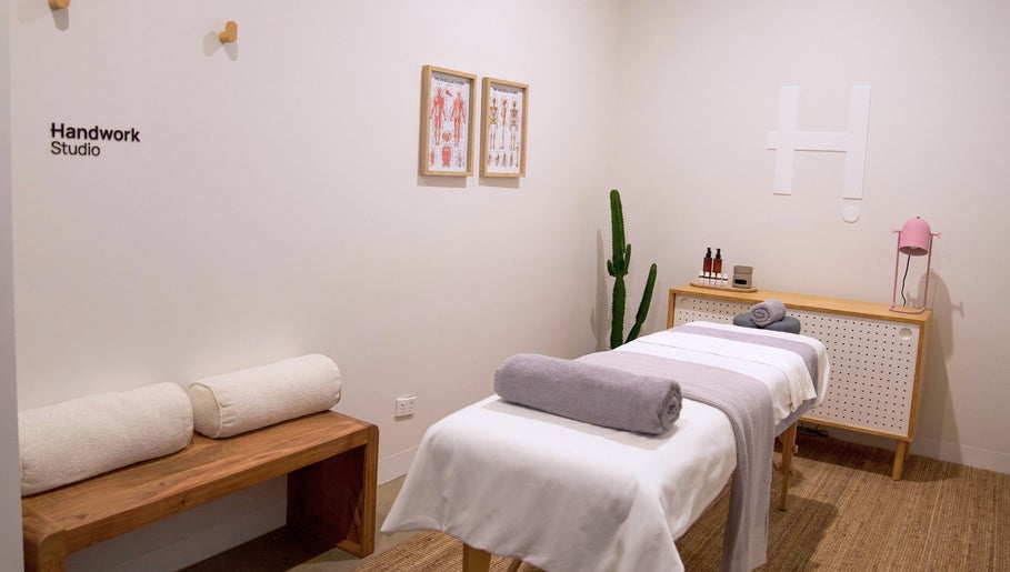 Relaxing massage room at Handwork Studio, Melbourne, Victoria, AU with a cozy setup and minimalist decor.