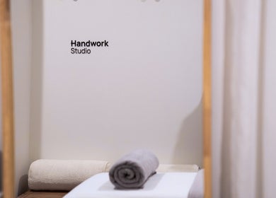 Relaxing treatment room at Handwork Studio, located in Melbourne, Victoria, AU, featuring a neatly rolled towel.