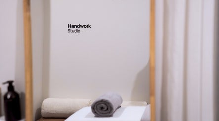 Relaxing treatment room at Handwork Studio, located in Melbourne, Victoria, AU, featuring a neatly rolled towel.