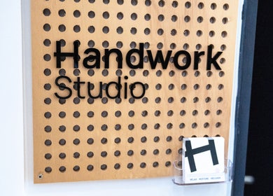 Handwork Studio sign in Melbourne, Victoria, AU on a perforated wooden board.