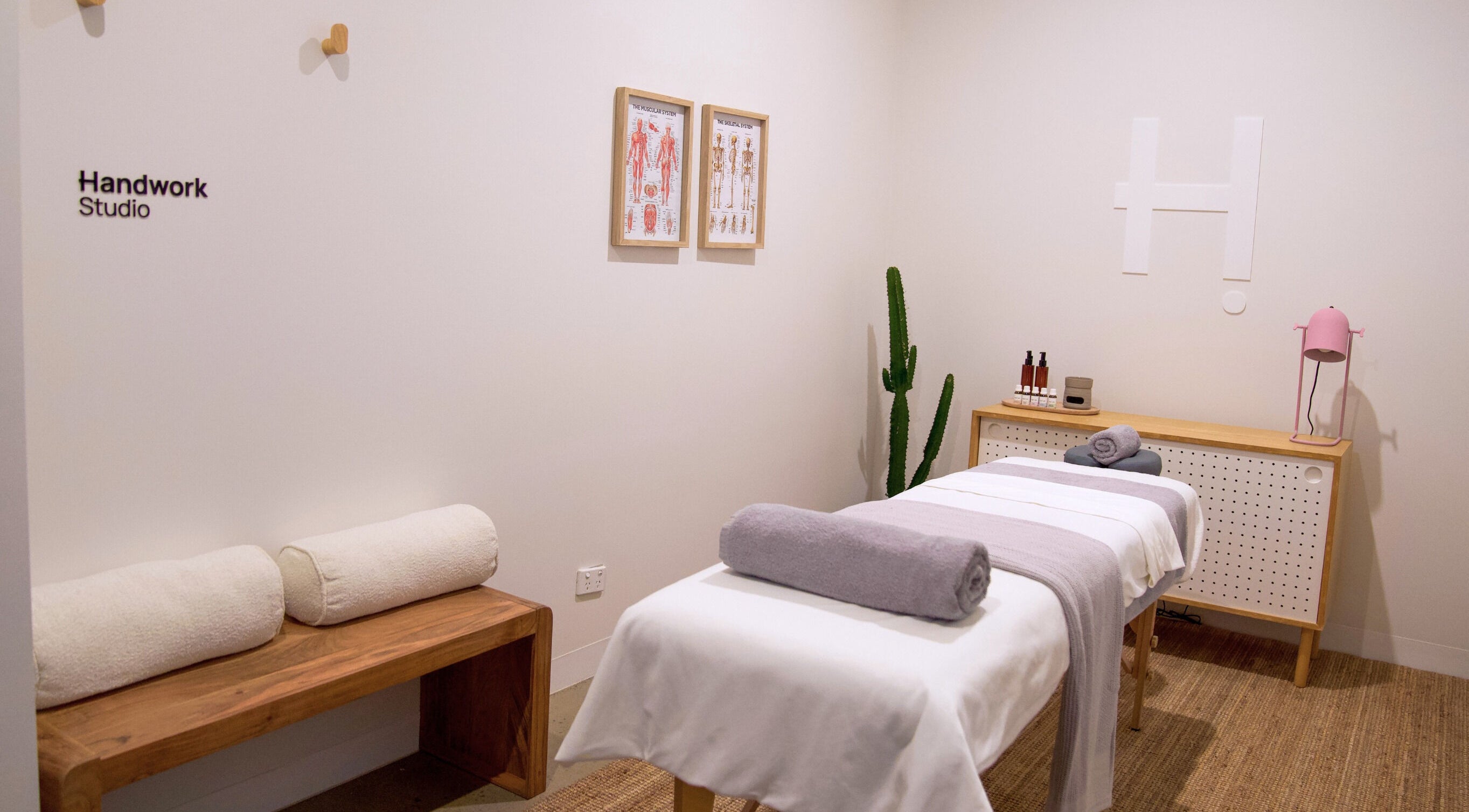 Serene massage room at Handwork Studio, Windsor, Victoria, AU featuring a neatly set massage table and decor.