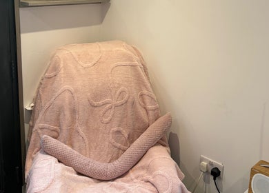 Comfortable pink chair in Pure IV and Aesthetics, Sarisbury Green, England, GB, offering a serene wellness environment.