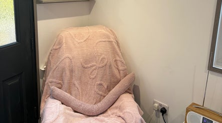 Comfortable pink chair in Pure IV and Aesthetics, Sarisbury Green, England, GB, offering a serene wellness environment.