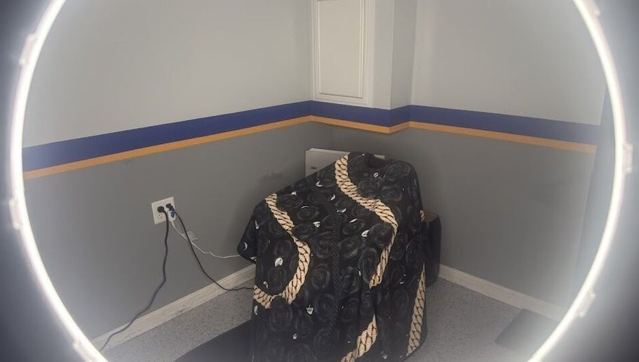 Cozy barber station at Daniel M Barbershop, Ashland, Massachusetts, US with a stylish chair cover.