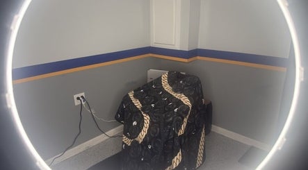Cozy barber station at Daniel M Barbershop, Ashland, Massachusetts, US with a stylish chair cover.