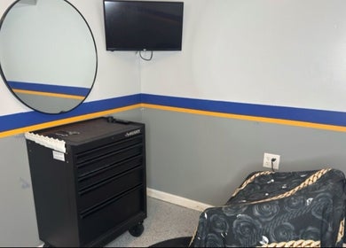Serene styling station at Daniel M Barbershop, Ashland, Massachusetts, US with mirror and tool chest.