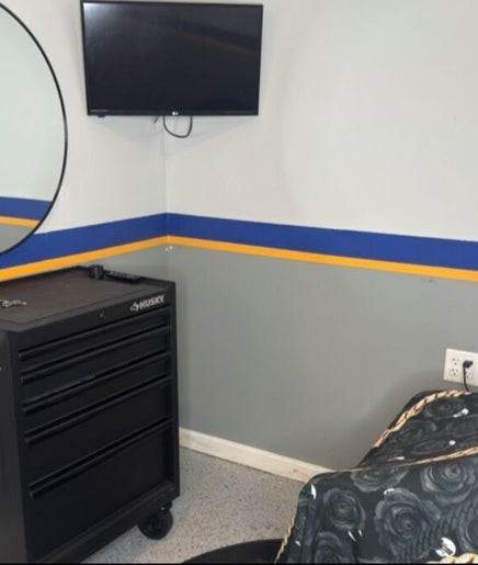 Serene styling station at Daniel M Barbershop, Ashland, Massachusetts, US with mirror and tool chest.