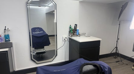 Modern salon setup at Danielz Blurry Blenz, Framingham, Massachusetts, US with stylish mirror and barber chair.